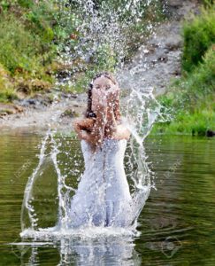 Young-woman-in-white-dress-in-a-river